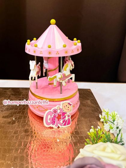 The charming pink musical carousel is a standout piece that makes this hamper a magical keepsake.