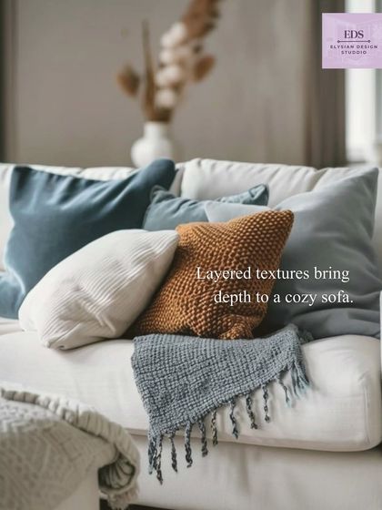 A close-up shot of layered textures on a sofa, with cushions in different materials and colors. This demonstrates our principle of using contrast to create depth and coziness.
