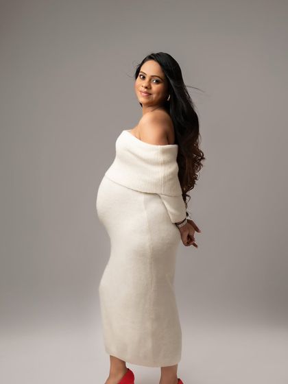 This cozy, off-shoulder sweater dress is perfect for a soft and intimate portrait. The pop of red shoes adds a touch of personality.