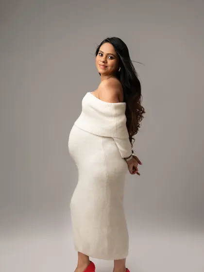 This cozy, off-shoulder sweater dress is perfect for a soft and intimate portrait. The pop of red shoes adds a touch of personality.
