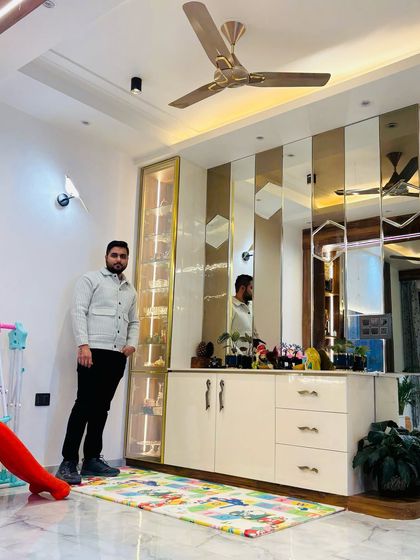 A wide shot of a completed project at Prateek Laurel, showcasing a mirrored crockery unit with integrated lighting.