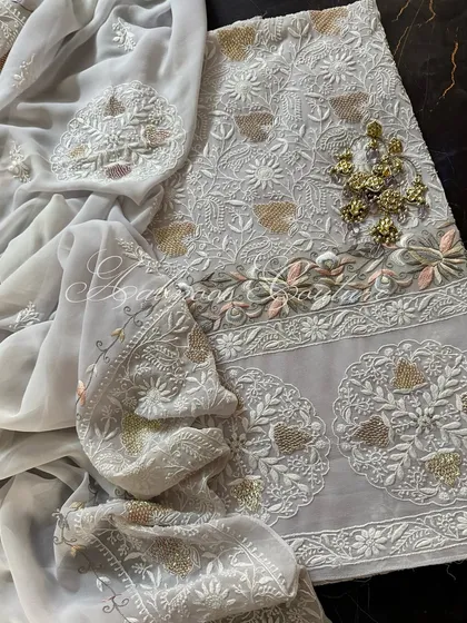 A draped view of the suit with traditional earrings, suggesting a complete look.
