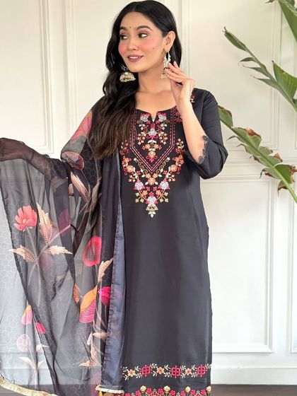 A classic black chanderi kurta with a colorful floral printed dupatta. The heavy thread embroidery on the neckline makes it a perfect blend of simple and festive.