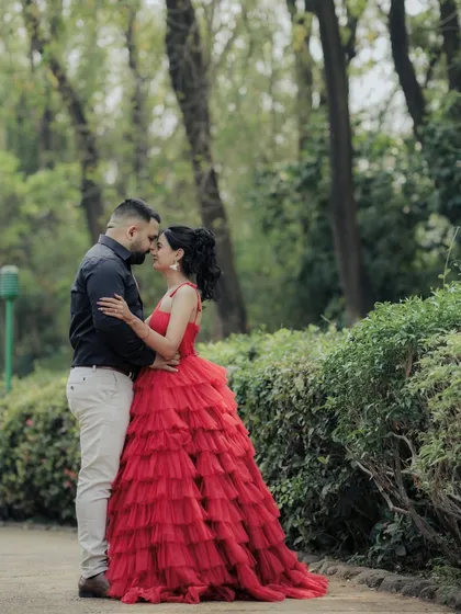 A tender moment of embrace between the couple in a beautiful Pune garden. The composition draws the eye to their connection, making it a perfect example of a romantic and cinematic engagement photo.