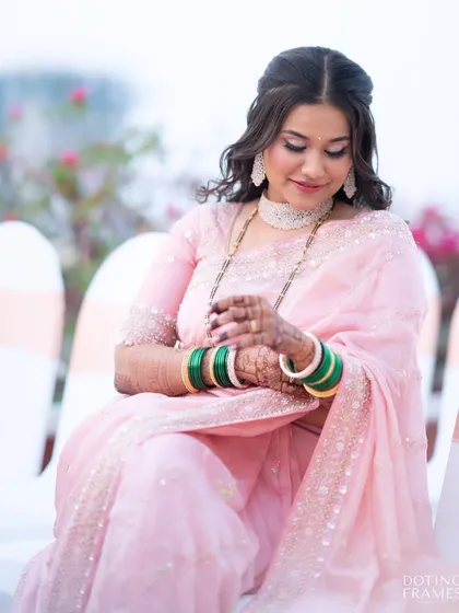 A candid moment showing the intricate details of her henna and the long-lasting finish of her makeup.