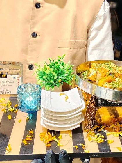 A member of our service staff presenting a tray of cheese steak toast with garlic sauce. Our team is trained to be professional and attentive, enhancing the overall guest experience at your event.