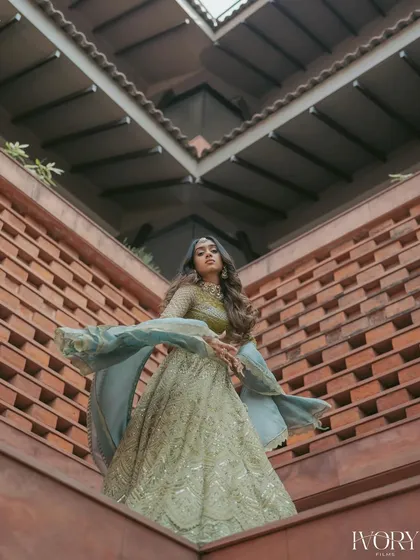 A powerful, artistic portrait of the bride. We use the surrounding architecture and shadows to create a dramatic and fashionable shot that highlights her poise.