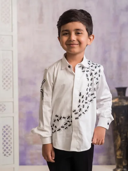 I love adding a fun twist to my designs, like this custom shirt with ant embroidery. It's a great example of how I can create a quirky yet smart outfit for birthdays or casual family functions.