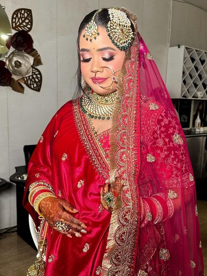 A soft, demure pose showing off the beautiful eye makeup and the intricate details of her bridal jewelry.
