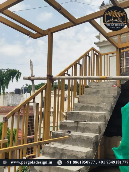 A detail shot of the work in progress, showing the connection between the new yellow steel staircase and the pergola frame. We ensure all structural elements are seamlessly integrated.