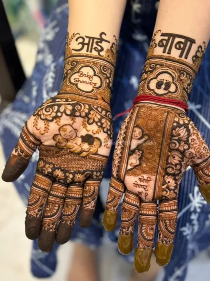 Another view of the baby shower mehendi celebrating the grandparents, showing the beautiful artwork on both hands.