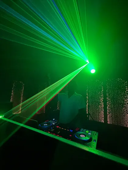 Me at the console, enveloped in a green laser grid. This kind of lighting setup transforms a venue and takes the party to the next level.