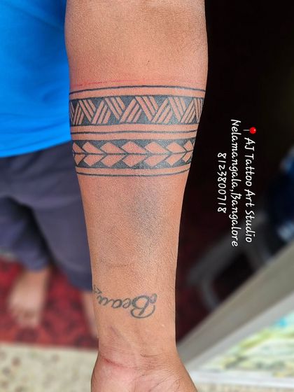 A traditional tribal pattern armband, a timeless and popular style.