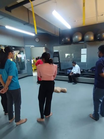 A group of students observes a CPR demonstration, learning the correct procedures and protocols.