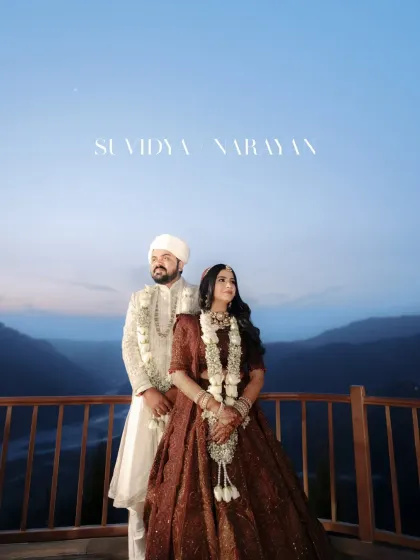 A classic wedding portrait of the couple against the twilight mountain sky, looking regal and deeply in love.