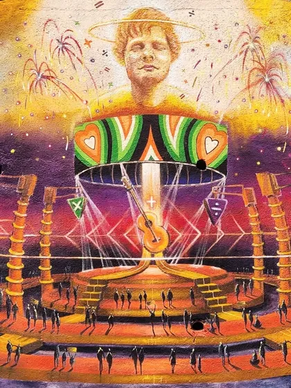 A detailed look at the central artwork for the Ed Sheeran tribute mural. The piece combines portraiture with abstract stage designs and symbols from his album, creating a visually rich composition.