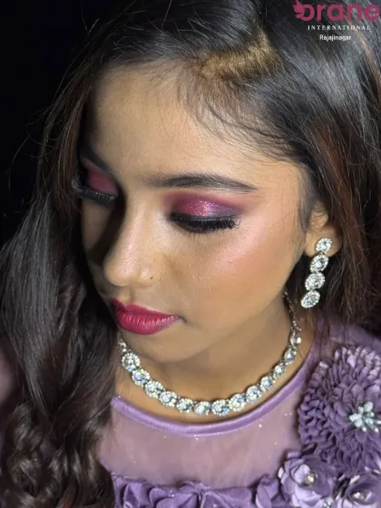 A close-up of the "Glam Doll" makeup, highlighting the shimmery pink eyeshadow and flawless base.