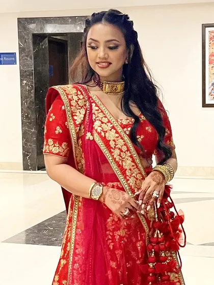 Subtle eyes with bold lips. This look combines a soft, shimmery eye with a classic red lip, a timeless combination for any bride.