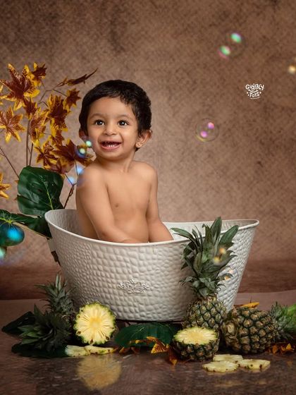 A fun and fruity bubble bath! This little one is having a blast surrounded by pineapples and bubbles.