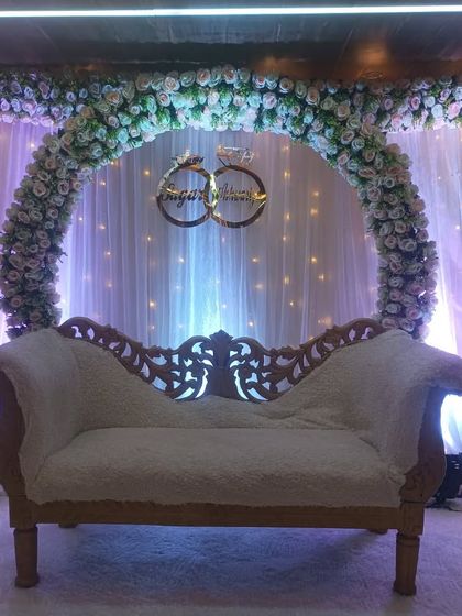 A close-up of the floral ring arch engagement decor. We use a mix of white and pink flowers to create a soft, romantic feel, complemented by a fairy light curtain.