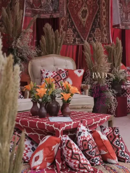 A cozy corner in our Moroccan-themed Mehendi, with floor seating, pampas grass, and rich, earthy tones. It's all about creating comfortable and stylish spaces for guests to relax.