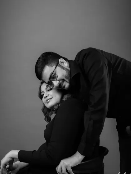 A classic black and white portrait. The makeup is structured to look beautiful and timeless, highlighting their connection and joy.
