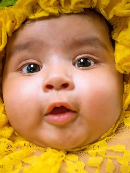 A wonderful close-up capturing a baby's chubby cheeks and curious expression. These detailed shots are perfect for remembering how tiny they were.