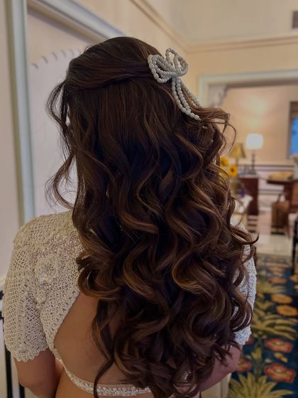 Another angle of the pearl bow, a unique and fashionable accessory for a cocktail or reception look.