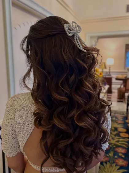 Another angle of the pearl bow, a unique and fashionable accessory for a cocktail or reception look.