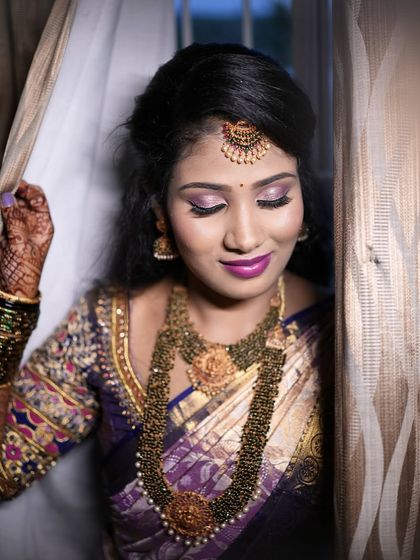 A soft and elegant portrait of Aarthi. The makeup is blended to perfection, creating a flawless finish.