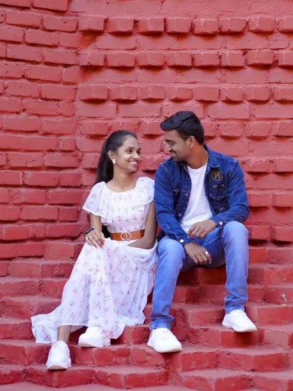 A sweet, intimate moment on a red brick staircase. This shows that romance can be found in simple, rustic settings.
