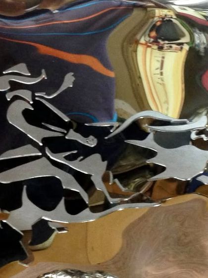 A close-up of the bull rider engraving, a narrative element on an abstract form.