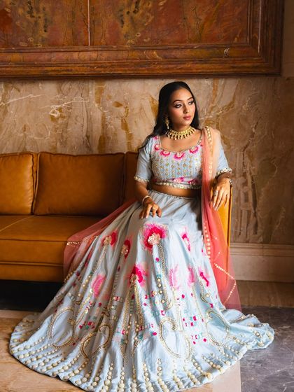 A full-length view of this pastel lehenga look, perfect for a carnival-themed Mehendi or a daytime sangeet. The soft colors of the outfit are complemented by a fresh and bright makeup look.