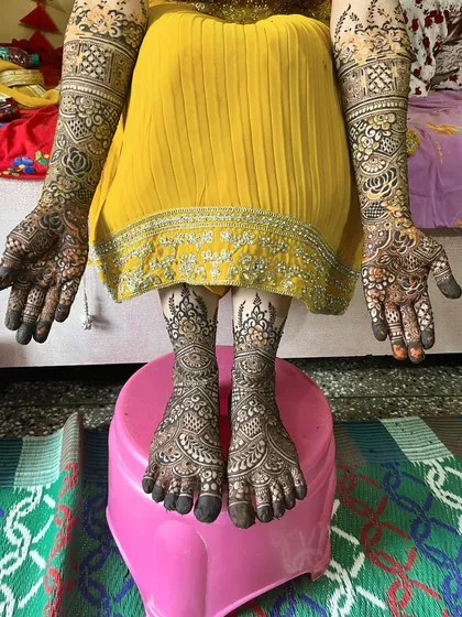 The complete bridal mehndi for Aain, with full coverage on her arms and feet.