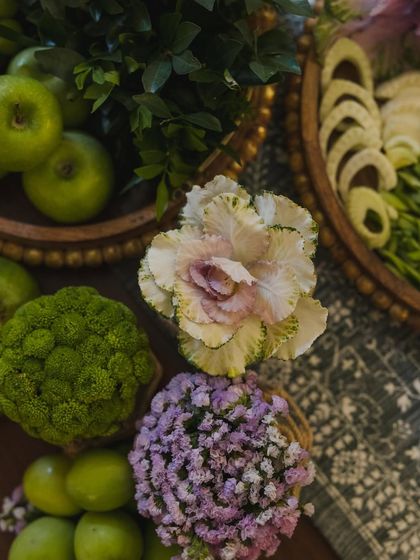 A close-up of the floral and fruit arrangements from the Mehendi, featuring ornamental cabbage, green apples, and other unique foliage.
