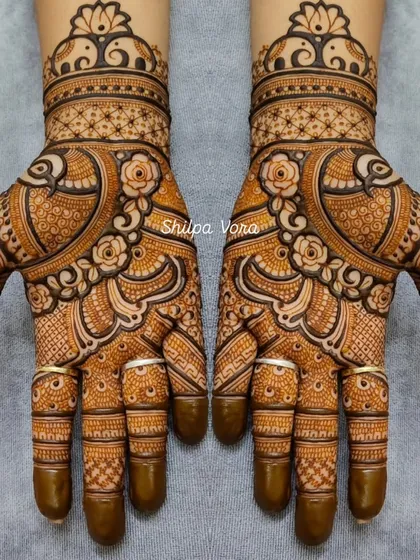 A beautiful Rajasthani design featuring peacocks and roses, with delicate line work and shading that creates a sense of depth.