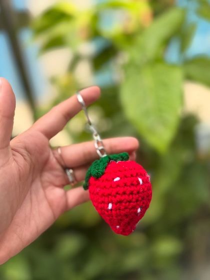 A sweet little strawberry keychain, perfect for adding a fruity touch to your keys or bag.