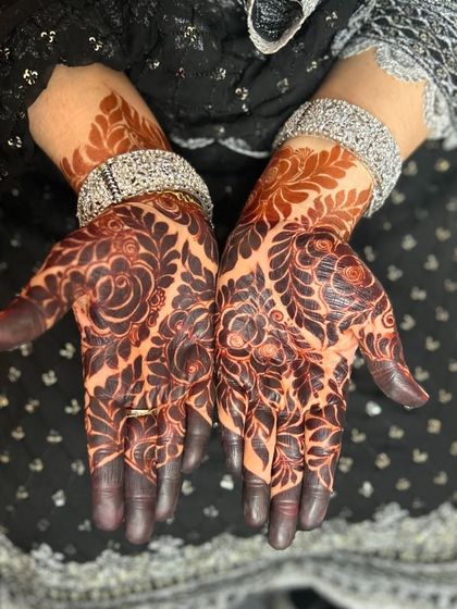 A stunning example of a mature henna stain. The color is a deep reddish-brown, and the floral design is still perfectly clear.