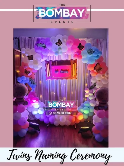 Double the joy! A beautiful butterfly-themed naming ceremony decoration for twins, featuring a colorful balloon arch and two baby foil balloons.
