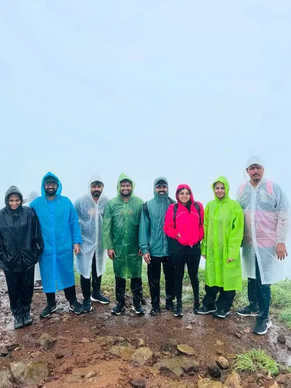 A group braving the rain and mist on the Tadiandamol trek, Coorg's highest peak. I ensure everyone is prepared for the weather to enjoy the adventure safely.