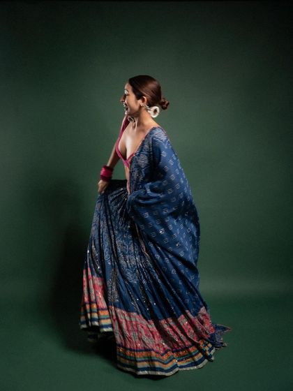 A side profile shot that captures the beautiful flare of the lehenga. The movement in the fabric adds a dynamic element to this ethnic wear photoshoot.
