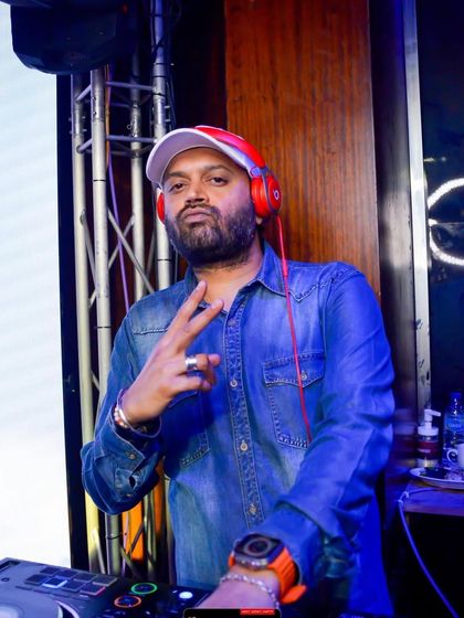 A classic DJ pose. In the zone, ready to drop the next beat.