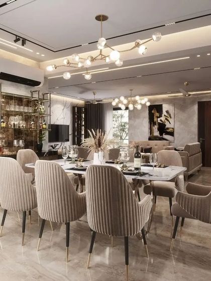 This opulent dining area in a Lucknow residence is designed for memorable gatherings. The setup includes a stylish bar cabinet for easy entertaining, a modern linear chandelier, and comfortable upholstered chairs, blending functionality with high-end design.