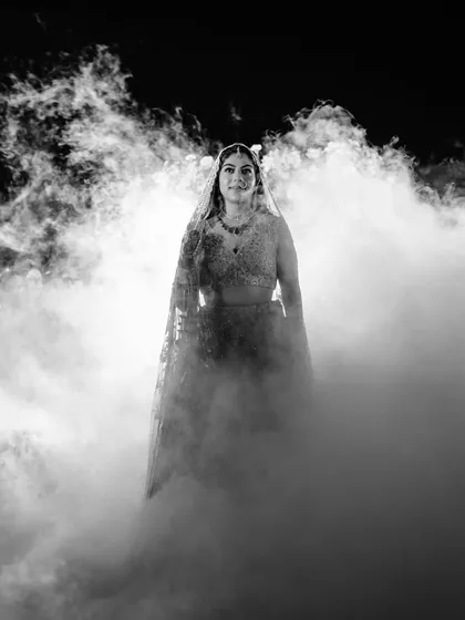 Sugam emerges from a cloud of dry ice as she walks the last few meters of the aisle alone. The look in her eyes is powerful, a symbol of her strength and independence as she steps into her future.