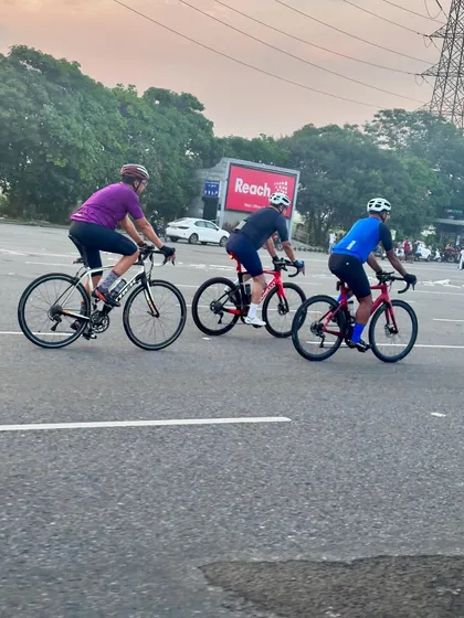 Three riders in a paceline, working together to cut through the wind.