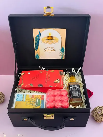 Another variation of the men's Diwali hamper. This one features a miniature whiskey, a bubble candle, a chocolate bar, and a tarot-style card.