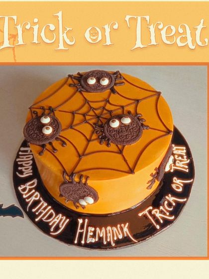 A "Trick or Treat" Halloween cake with a spiderweb design and creepy-crawly Oreo spiders.