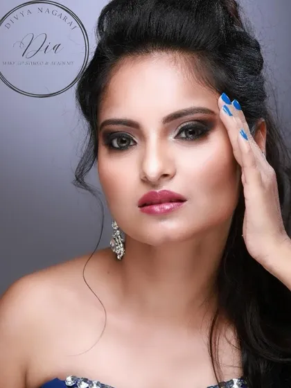 A classy cocktail look. This features a dark, sultry smoky eye with a glossy lip, paired with voluminous hair for a look that is ready for any glamorous party.