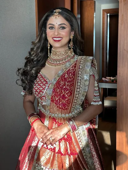 The full picture of bridal radiance. Her smile says it all. This classic bridal look with a red lip and defined eyes was designed to be timeless and elegant.