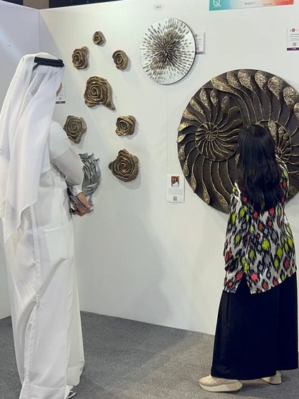 A visitor admiring my large nautilus sculpture at the Qatar show. It's always fascinating to see which pieces draw people in.